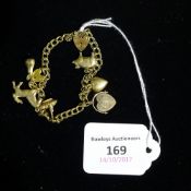 A 9 ct gold charm bracelet and charms (12 grammes all in)