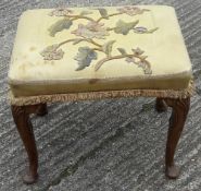 An 18th century style walnut stool with an embroidered tapestry covered seat