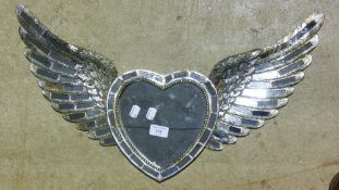 A silvered winged heart mirror