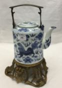 A blue and white kettle on stand