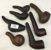 A quantity of leather pipe cases