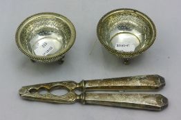 A pair of silver plated salts and nutcrackers