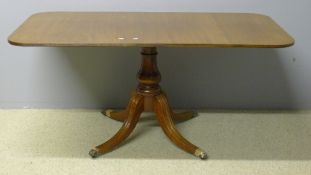 A mahogany tilt top dining table