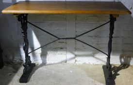 A pine topped cast iron pub table