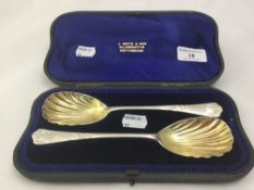 A pair of cased silver serving spoons