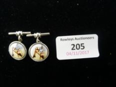 A pair of silver cufflinks depicting a pair of lady's legs