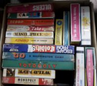 A box of various vintage board games,