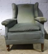 An early 20th century wing back armchair