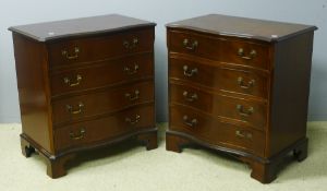 A pair of reproduction serpentine chest of drawers