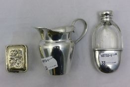 A miniature silver mounted hip flask together with a silver cream jug and pill box