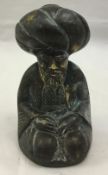 A small bronze figure of an Eastern man