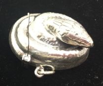 A silver vesta in the form of a snake