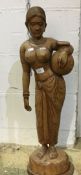 A carved wooden figure of a girl