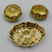 A Royal Crown Derby dish together with two trinket boxes and covers