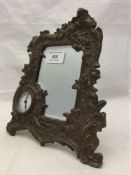 A framed mirror with integral clock