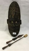 A tribal mask and two spear heads