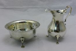 A silver cream jug and sugar bowl