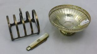 A silver tazza together with a silver toast rack and a silver bladed fruit knife