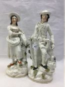 A pair of 19th century Staffordshire figures of a huntsman and his companion