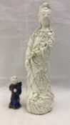 A Chinese blanc de chine figure of Guanyin and a small porcelain figure of a boy