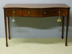 A reproduction serpentine serving table