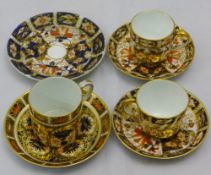 A pair of Royal Crown Derby miniature cups and saucers; a coffee can and saucer;