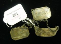 Three silver wine labels