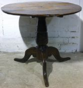 A Georgian oak tilt top tripod table