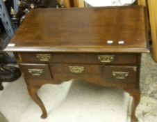 An 18th century and later walnut and mahogany lowboy