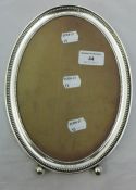 A sterling silver oval photo frame, stamped Bailey,