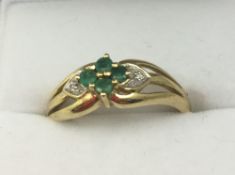 A 9 ct gold diamond and emerald ring