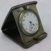 A silver cased travelling timepiece