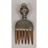 An African tribal carved wooden comb The handle carved as a mask. 26.5 cm long.