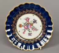A Worcester porcelain dish Of gilt heightened scalloped shape, centrally painted with floral sprays,