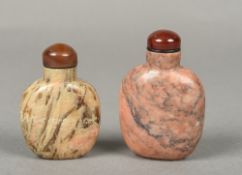 Two Chinese carved hardstone snuff bottles and stoppers 7.5 and 6.5 cm high.