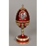 A Russian silver gilt diamond and ruby set enamel decorated clock Formed in the shape of a hinged