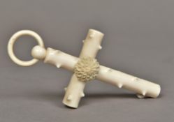 A Victorian carved ivory crucifix Faux bois centred with a rosette, with suspension ring.