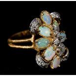 A 14 K gold, opal and diamond cluster ring 2.5 cm high.