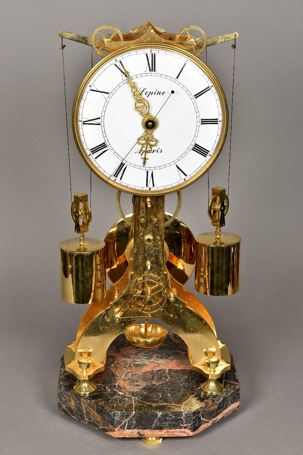 A lacquered brass skeleton clock The 9 inch white enamelled dial signed Lepine,