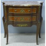 A French brass mounted marble topped commode The shaped top above two parquetry panelled shaped