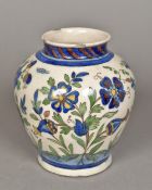 A Qajar pottery vase Typically decorated with floral sprays. 18 cm high.