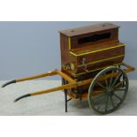 A barrel organ and cart Of typical form, in small proportions with painted decoration.