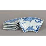 A set of five 18th century Japanese blue and white Arita porcelain fan shaped dishes Each decorated