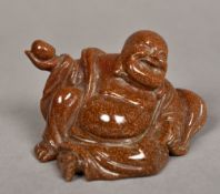 A Chinese carved gold stone Buddha Modelled recumbent. 6 cm high.