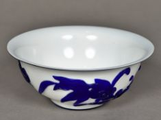 A Chinese Peking glass bowl Blue flashed on a white ground and decorated with an aquatic scene.