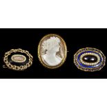 A Victorian unmarked yellow metal framed cameo brooch Of oval form,