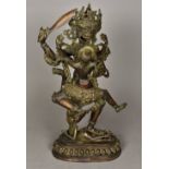 An Eastern cast bronze figure of a dancing deity With female attendant,