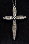 A 10K gold diamond set cross form pendant Suspended on a 10K white gold chain,