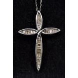 A 10K gold diamond set cross form pendant Suspended on a 10K white gold chain,