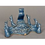 A Chinese porcelain brush holder Centred with a mythical beast mask with allover blue glaze.